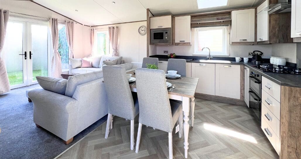 The image showcases the interior of a luxury lodge, featuring a modern kitchen and a comfortable living space, perfect for relaxing during a holiday at Patrington Haven Leisure Park. With stylish furnishings and an inviting atmosphere, this lodge offers a great base for exploring the beautiful East Yorkshire coast and countryside views.